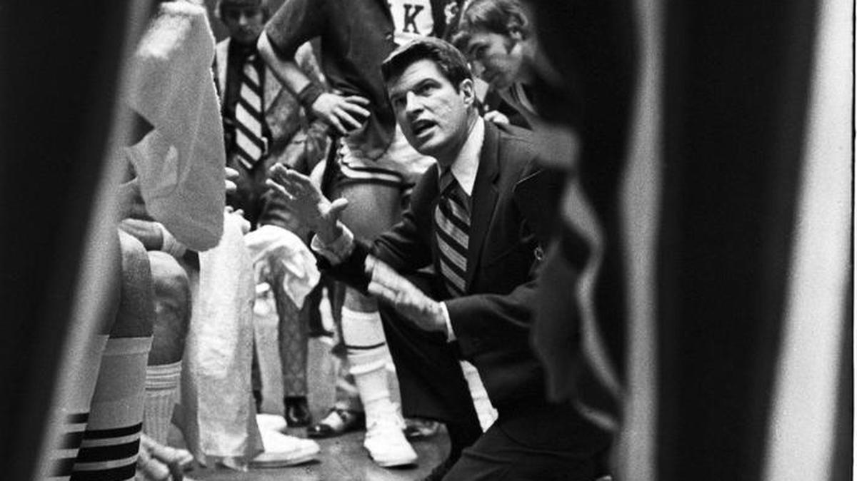 Duke head coach Bucky Waters gives instructions to his players in a huddle at the bench during a 1972 ACC Basketball Tournament game.