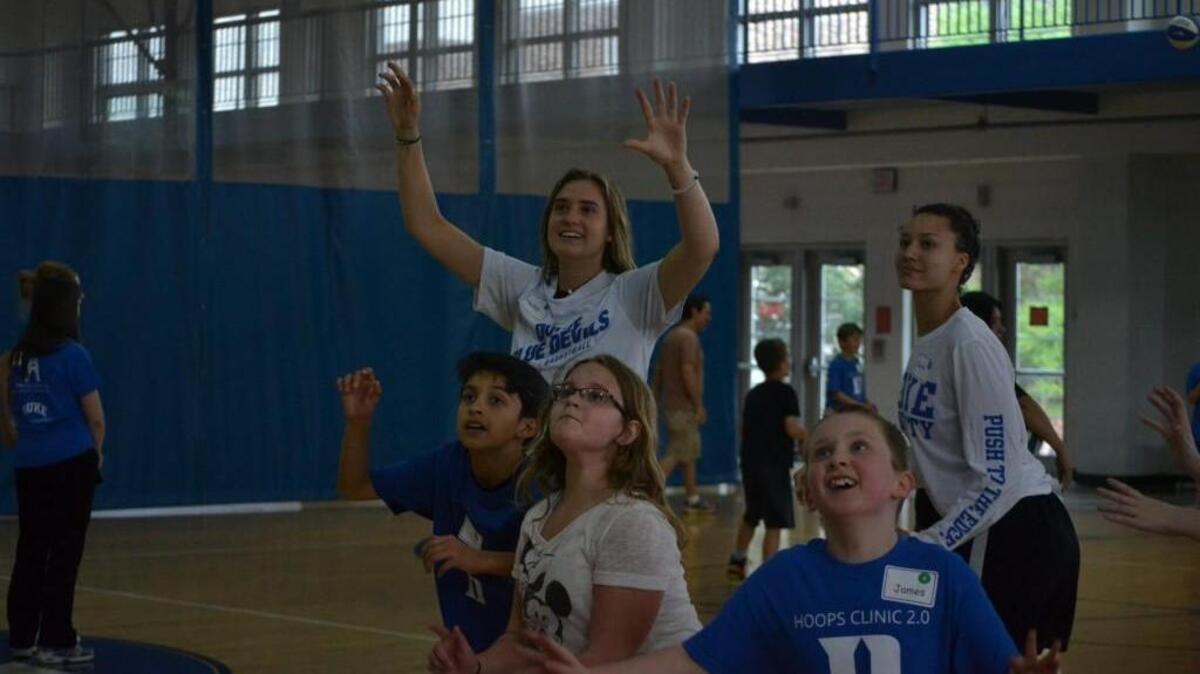 Duke guard Haley Gorecki, center, plays with children during the a basketball clinic hosted by the school’s Center for Autism and Brain Development at the Wilson Recreation Center on Thursday.