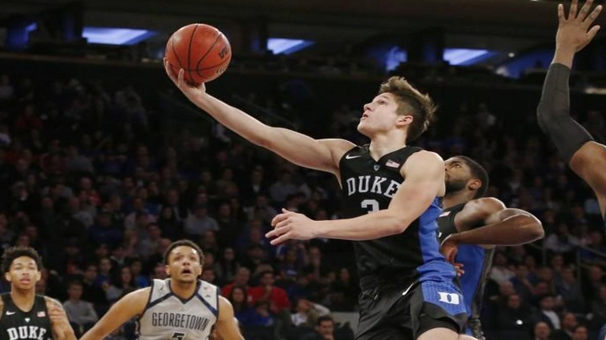 Duke guard Grayson Allen (3) goes up for a layup as Georgetown forward Reggie Cameron (5) watches from the floor in the first half at Madison Square Garden in New York.