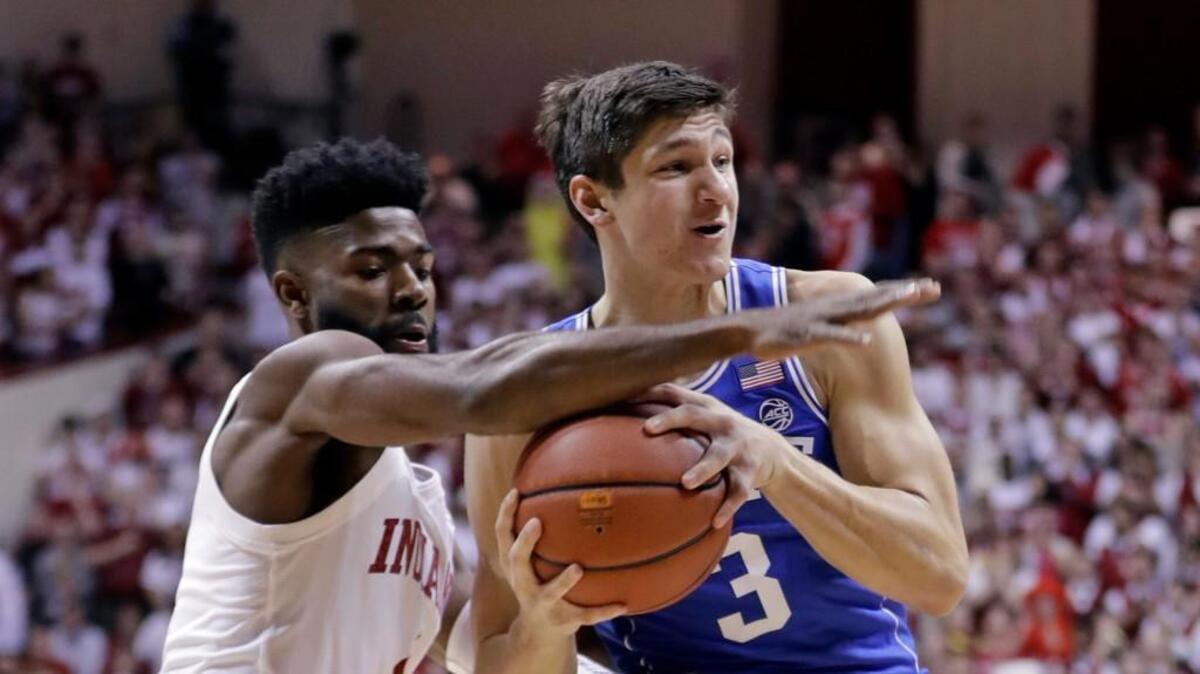 Indiana guard Robert Johnson (4) knocks the ball away from Duke guard Grayson Allen (3) during the first half of an NCAA college basketball game, Wednesday, Nov. 29, 2017, in Bloomington, Indiana.
