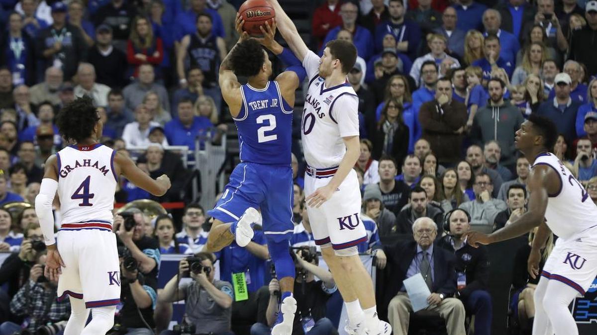 Kansas' Svi Mykhailiuk (10) blocks a shot by Duke's Gary Trent Jr. (2) in overtime of Kansas' 85-81 victory over Duke in the Midwest Regional Final at CenturyLink Center in Omaha, Neb., on March 25, 2018.