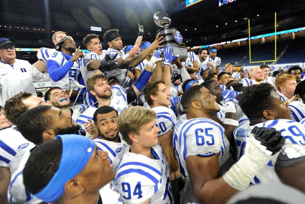 Duke players hoist their championship trophy after defeating Northern Illinois 36-14 in the Quick Lane Bowl NCAA college football game, Tuesday, Dec. 26, 2017, in Detroit.