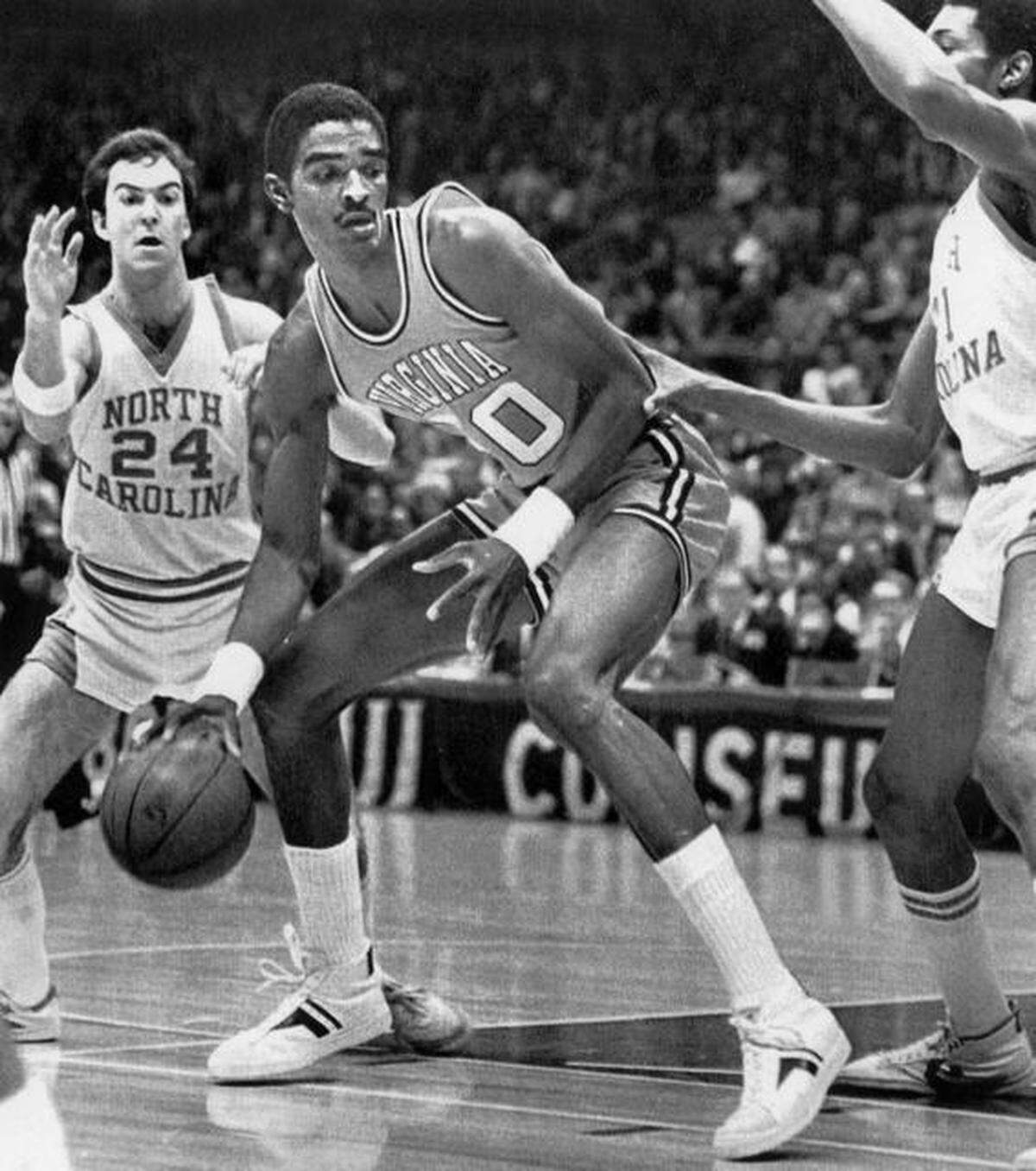 Ralph Sampson (50), a Virginia standout who stood 7-foot-4, works toward the basket as North Carolina’s Jim Braddock (24) and Jimmy Black (21) attempt to guard him.