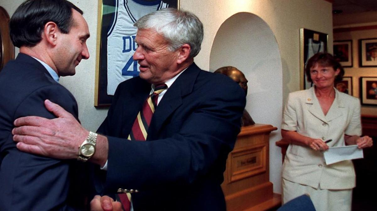 Duke basketball coach Mike Krzyzewski, left, congratulates athletic director Tom Butters after Butters announced his retirement.