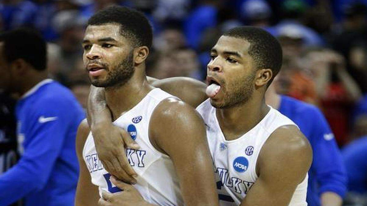 
Kentucky's Aaron Harrison, right, embraces his brother Andrew as they walk off the court following a 64-51 win against Cincinnati in the third round of the NCAA Tournament on Saturday, March 21, 2015, at the KFC Yum! Center in Louisville, Ky. (Mark Cornelison/Lexington Herald-Leader/TNS)
