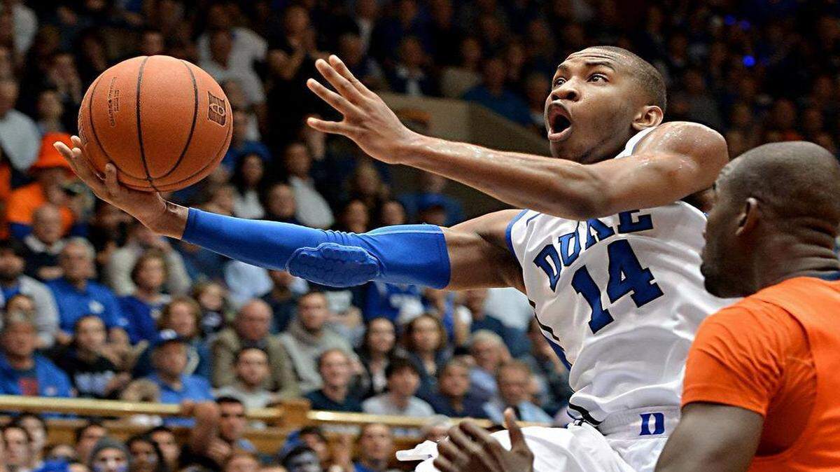 
Rasheed Sulaimon  scores in the second half as Syracuse center Baye Moussa Keita  defends.The former Duke guard is transferring to Maryland, where he can play immediately if he graduates from Duke in August. 
