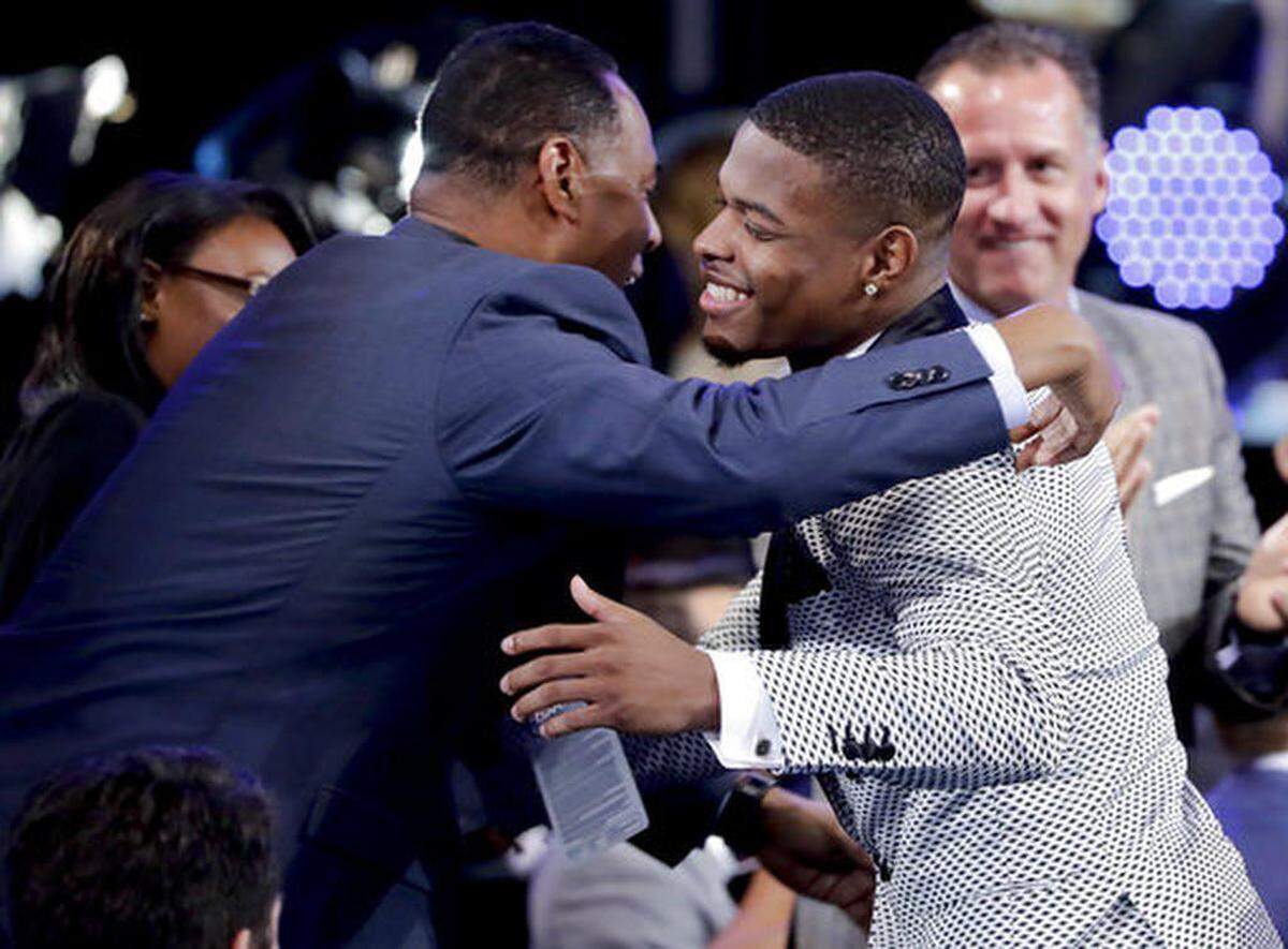 Dennis Smith Jr., right, is congratulated by family and friends after being selected by the Dallas Mavericks as the ninth pick overall during the NBA basketball draft, Thursday, June 22, 2017, in New York.