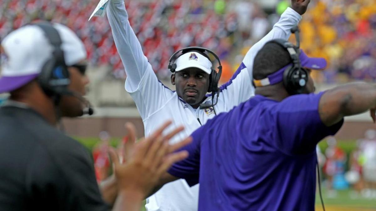 East Carolina head coach Scottie Montgomery cheers as the Pirates stop NC State on 4th down in September.