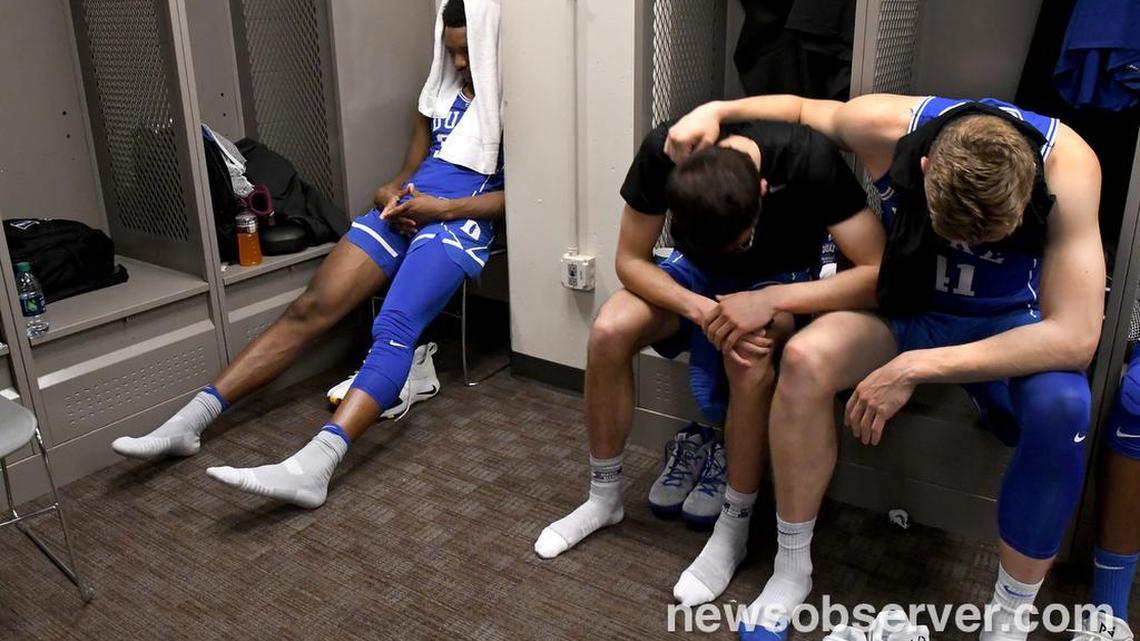 Duke players Wendell Carter Jr (34), Brennan Besser (53) and Jack White (41) sit in quiet desperation in the locker room as the Blue Devils lost to Kansas in OT 85-81 in the NCAA Elite 8 , Sunday, March 25, 2018 at the CenturyLink Center in Omaha., Neb.