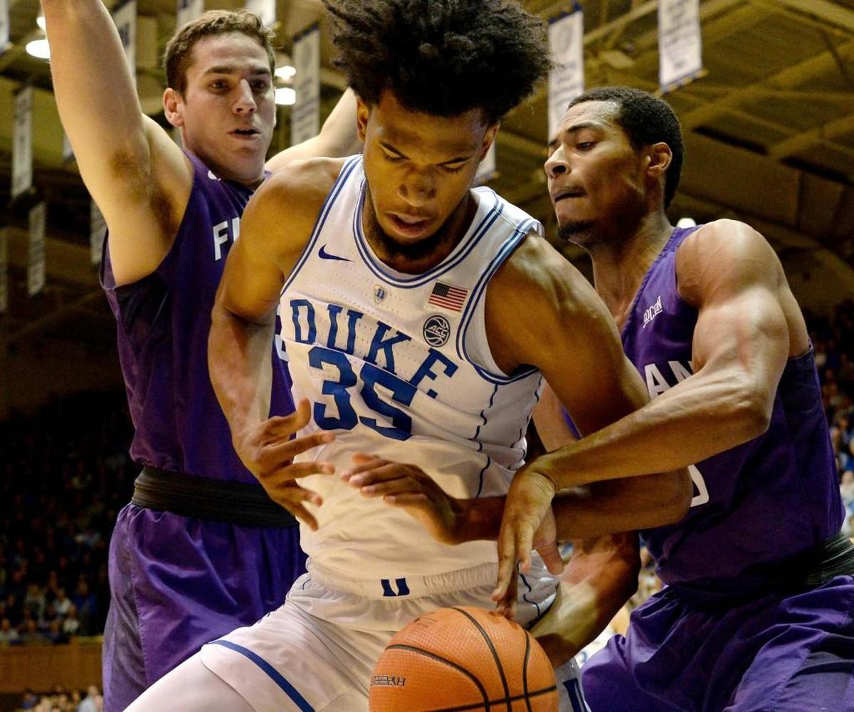 Duke forward Marvin Bagley III (35) wrestles for a rebound with Furman guard Daniel Fowler (35) in the first half.