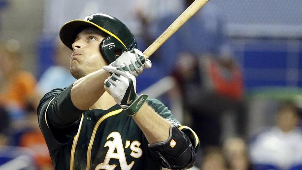 Oakland Athletics Nate Freiman watches the ball after he hit a three-run home run during the sixth inning of a baseball game, Sunday, June 29, 2014 in Miami. The Athletics defeated the Marlins 4-3. (AP Photo/Wilfredo Lee)