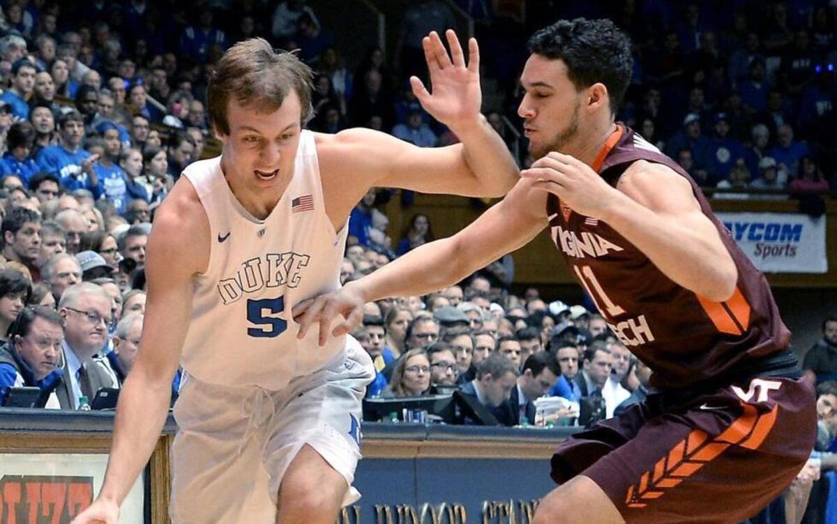 Duke guard Luke Kennard (5) tries to get around Virginia Tech guard Devin Wilson (11) during Duke’s 82-58 victory at Cameron Indoor Stadium in Durham Saturday, January 9, 2016.