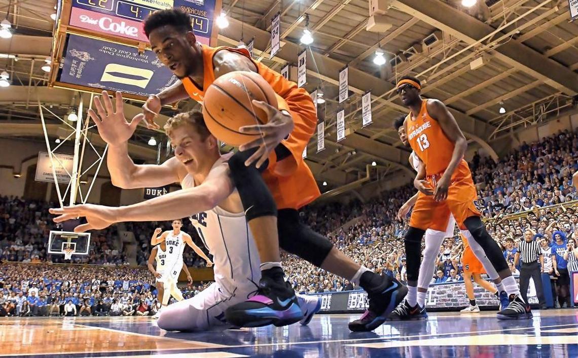 Duke forward Jack White (41) and Syracuse forward Oshae Brissett (11) battle for a loose ball in the first half. Duke battled Syracuse at Cameron Indoor Stadium In Durham, N.C. Saturday, Feb. 24, 2018.