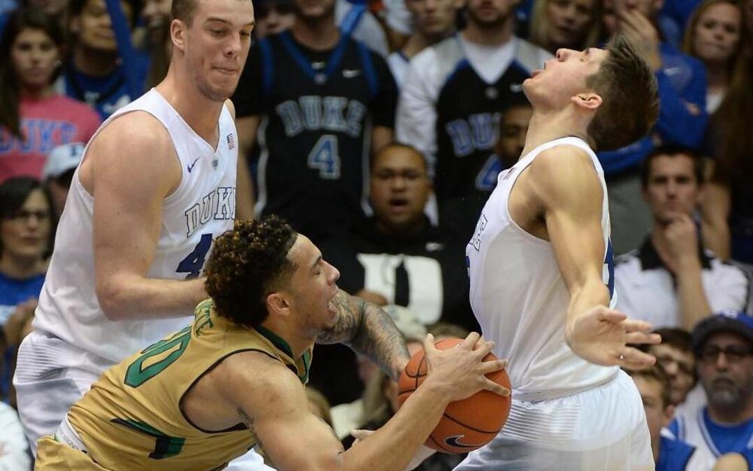 Duke’s Grayson Allen, right, gets hit in the mouth by Notre Dame’s Zach Auguste (30) in the first half of play at Cameron Indoor Stadium.