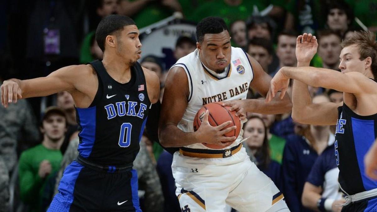 Jayson Tatum (0) and Luke Kennard (5) try to steal the ball from Notre Dame’s Bonzie Colson (35) in Duke’s 84-74 win on Jan. 30.