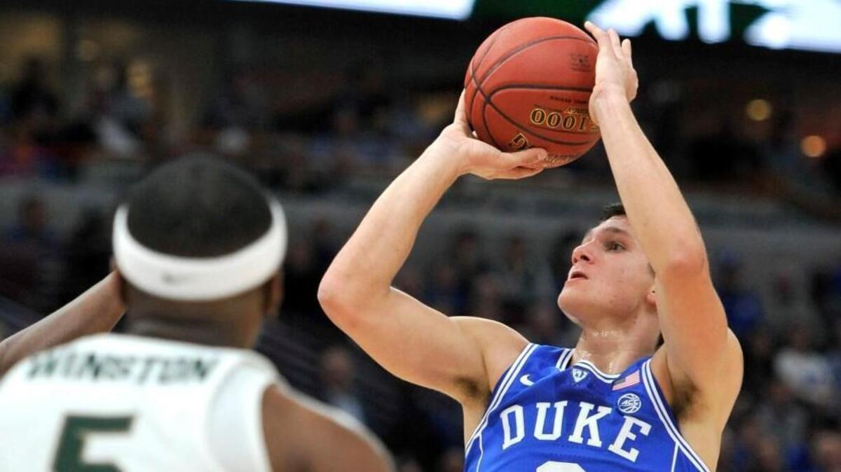 Duke guard Grayson Allen shoots as Michigan State guard Cassius Winston (5) watches during the first half.