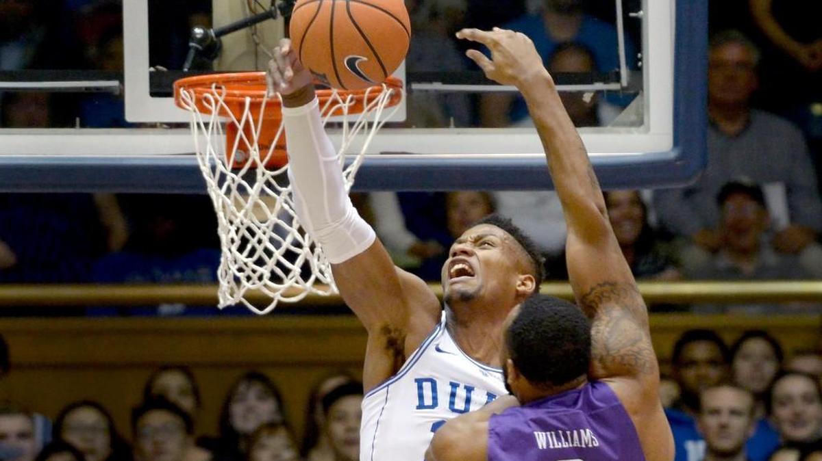 Duke forward Javin DeLaurier (12) goes up to block a first half shot by Furman forward Jalen Williams (2). Duke defeated Furman 92-63, Monday, Nov. 20, 2017 at Cameron Indoor Stadium in Durham, N.C.