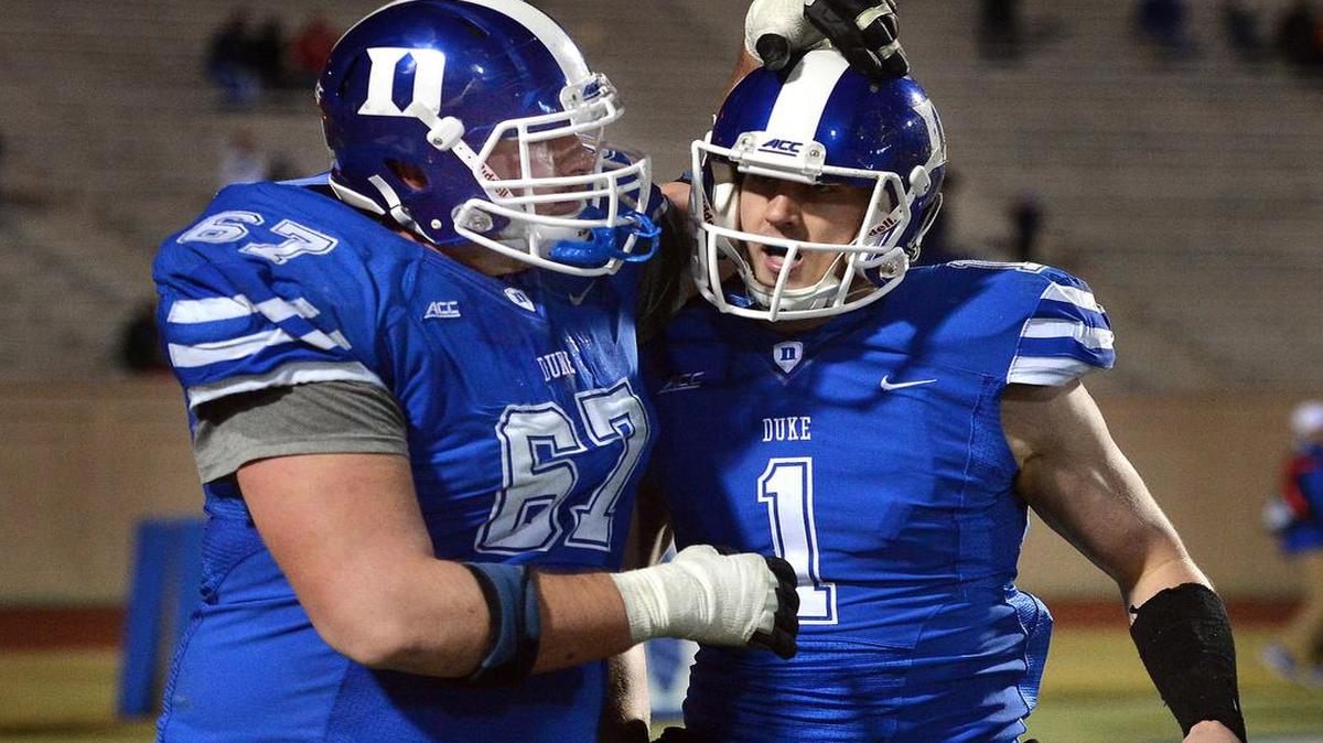 
Duke quarterback Thomas Sirk (1) is congratulated by guard Lucas Patrick (67) after throwing a fourth-quarter touchdown against Wake Forest on Nov. 29, 2014 in Durham.
