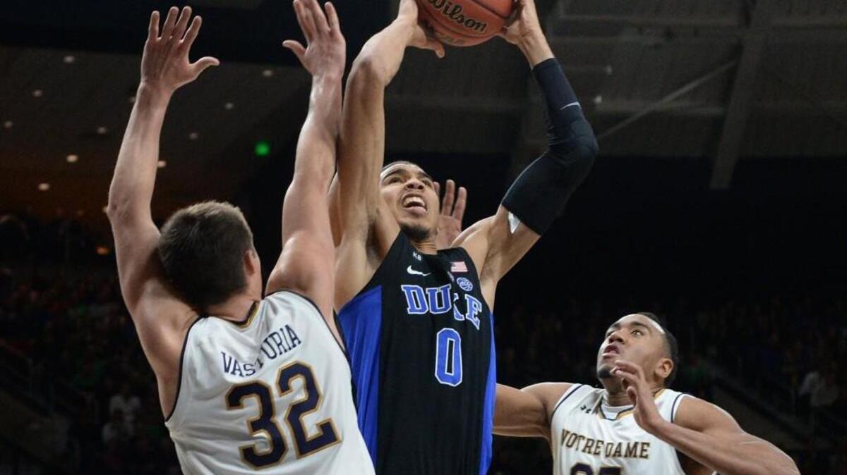 Duke forward Jayson Tatum, center, grabs a rebound over Notre Dame’s Steve Vasturia, left, and Bonzie Colson, right. Duke beat Notre Dame 84-74 on Jan. 30.