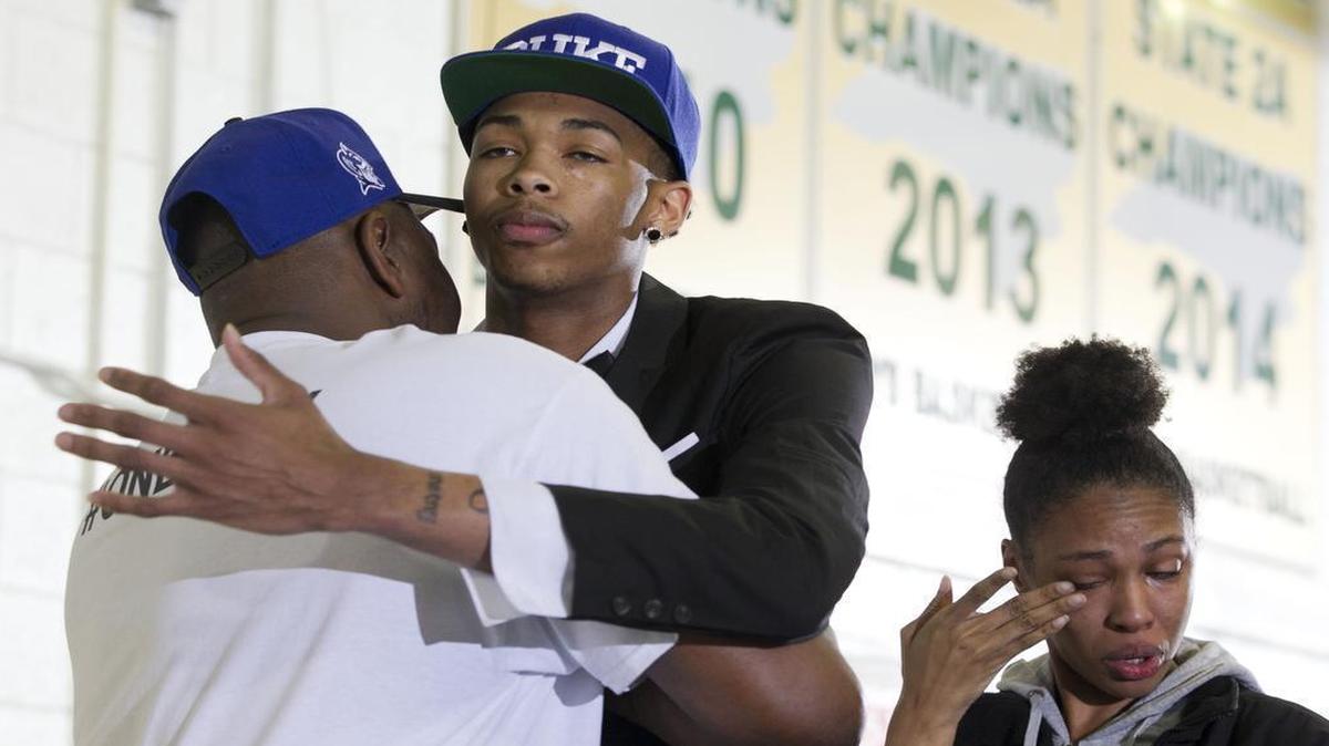 
Highly recruited basketball player Brandon Ingram, a senior at Kinston High School, announces that he will attend Duke University on Monday, April 27, 2015 at Kinston High School in Kinston. Ingram embraces his father Donald Ingram as his sister Brittany Callender wipes away tears following the announcement.
