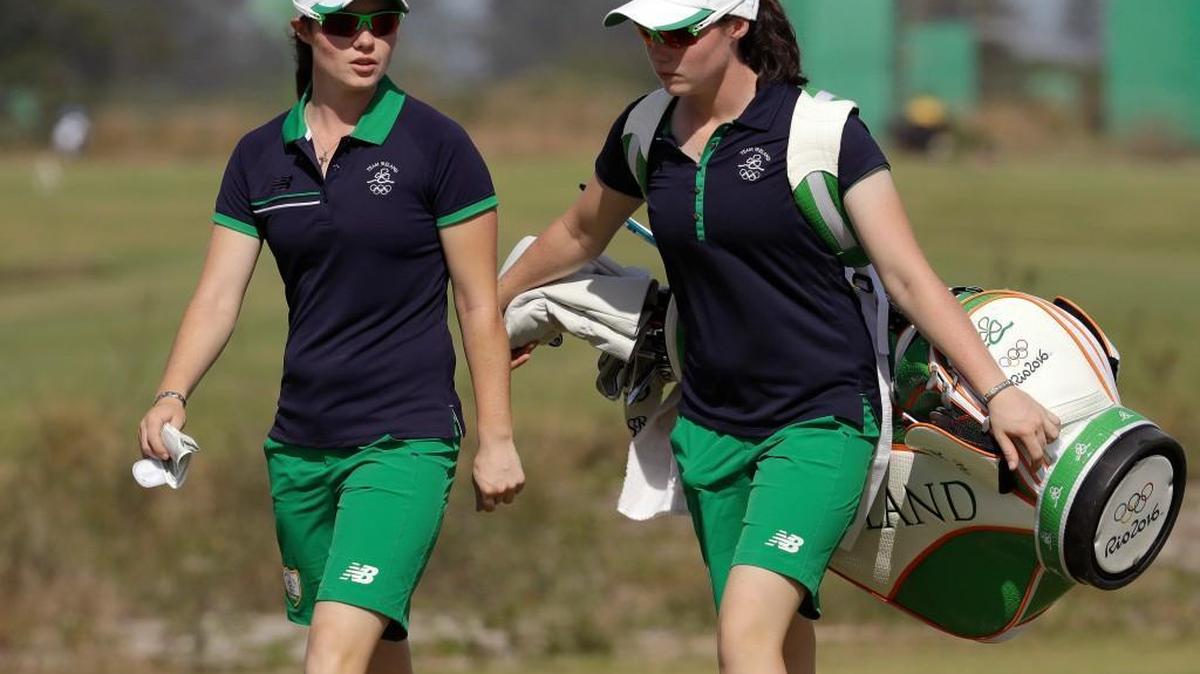 Leona Maguire, left, of Ireland, walks up the 18th fairway with Lisa Maguire, right, her twin sister and caddie, during a practice round for the women's golf event at the 2016 Summer Olympics in Rio de Janeiro, Brazil, Tuesday, Aug. 16, 2016.