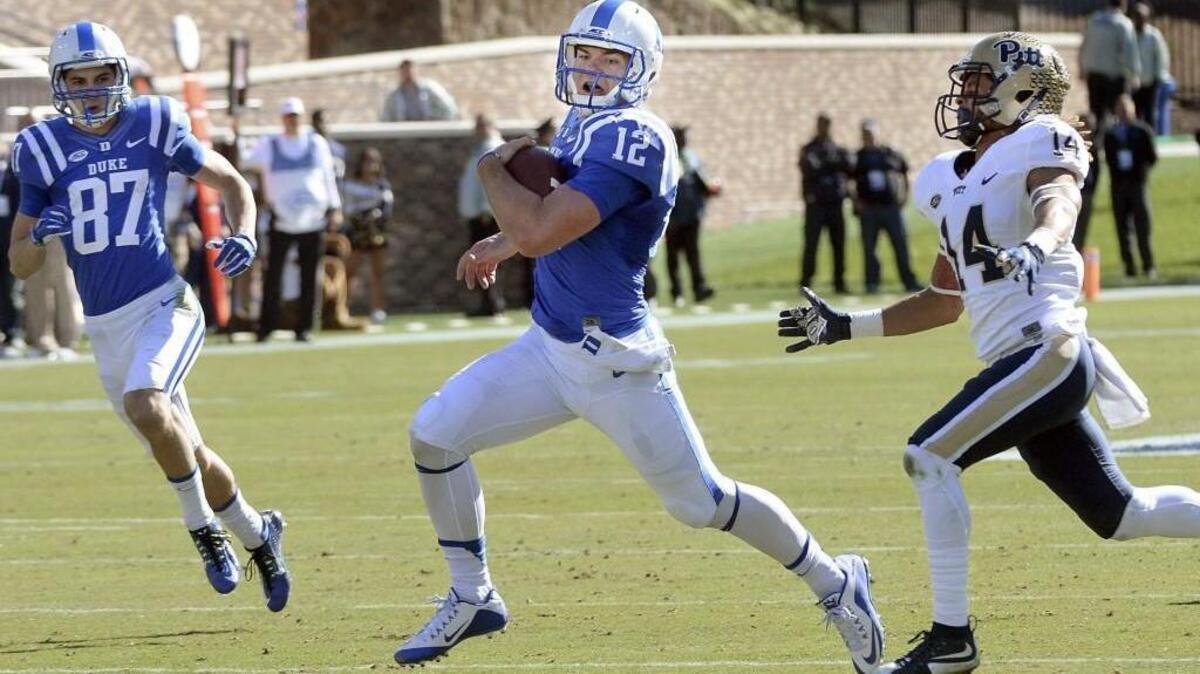 Duke quarterback Parker Boehme, center, outruns Pitt defensive back Avonte Maddox during a 77-yard run in the Blue Devils’ 31-13 loss to the Panthers Saturday.