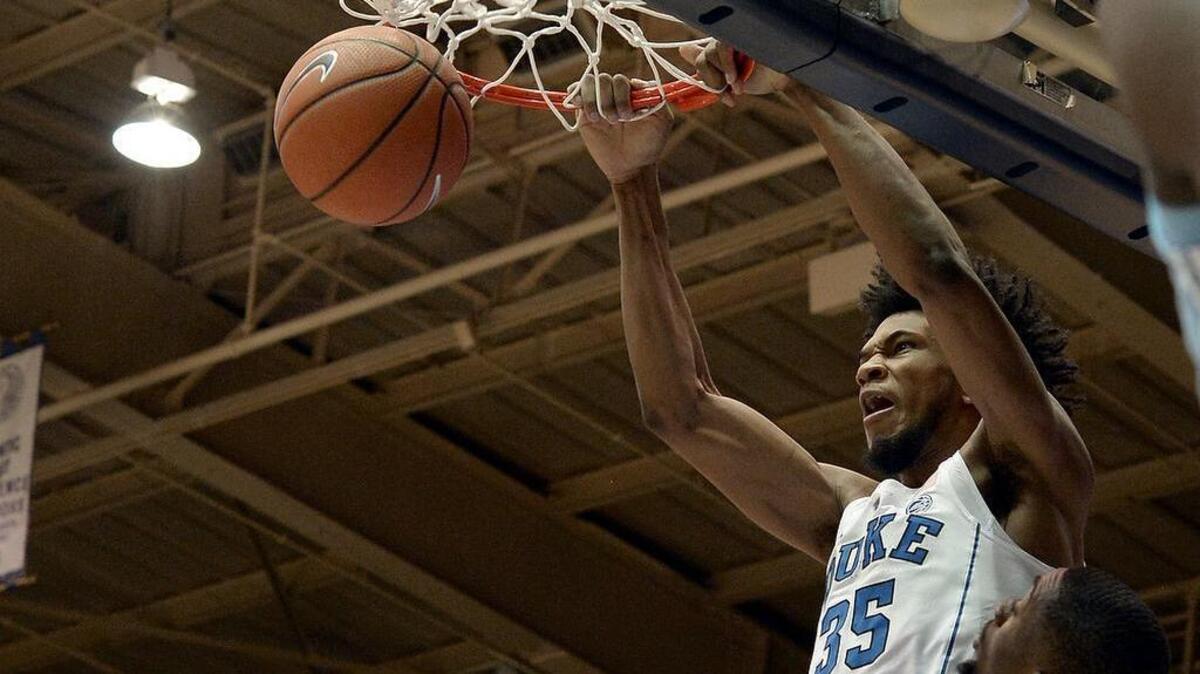 Duke's Marvin Bagley III (35) scores two first half points over UNC's Brandon Robinson (4). Duke defeated UNC 74-64 at Cameron Indoor Stadium In Durham, N.C. Saturday, March 3, 2018.