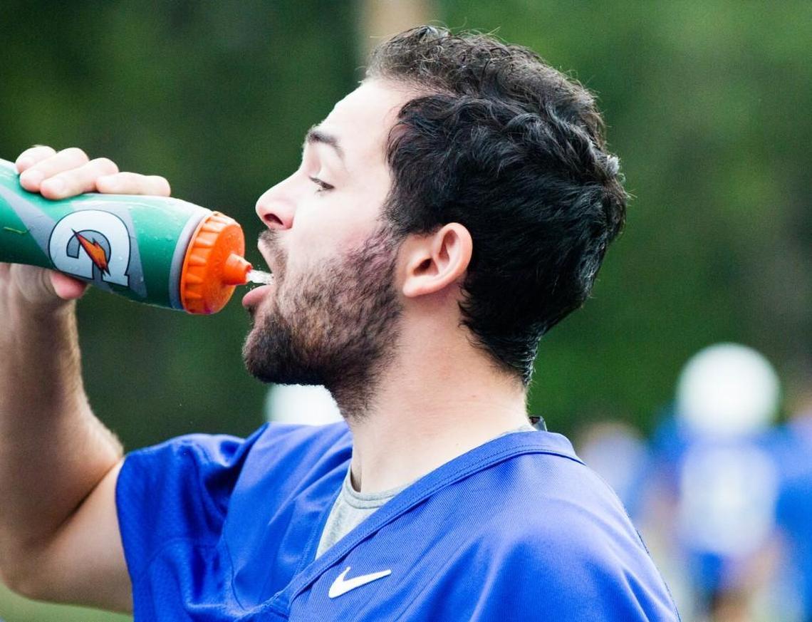 William Holmquist, a walk on kicker for the Duke football team, rehydrates at practice on Aug. 2.