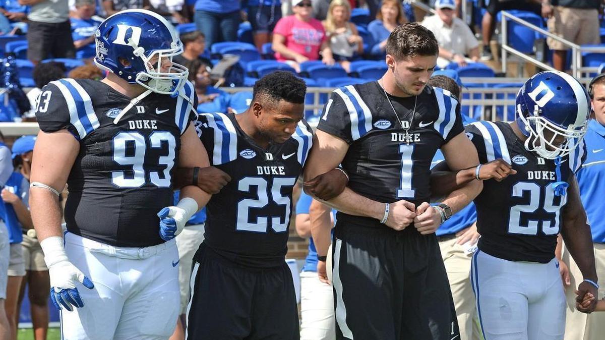 Duke’s A.J. Wolf (93), Jela Duncan (25), Thomas Sirk (1) and Shaun Wilson (29) get ready to walk out for the coin toss before the Blue Devils’ game against Virginia on Oct. 1.