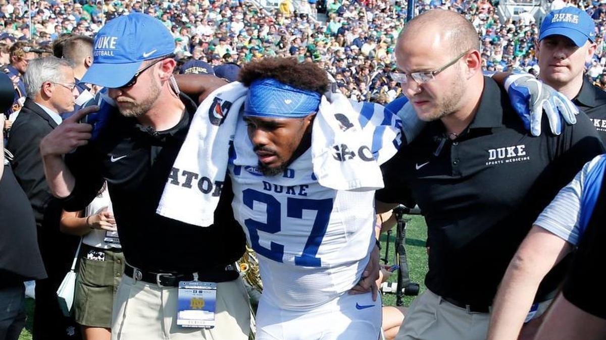 Duke safety DeVon Edwards, center, is taken to the locker room after a left leg injury during the first half against Notre Dame in South Bend, Ind.