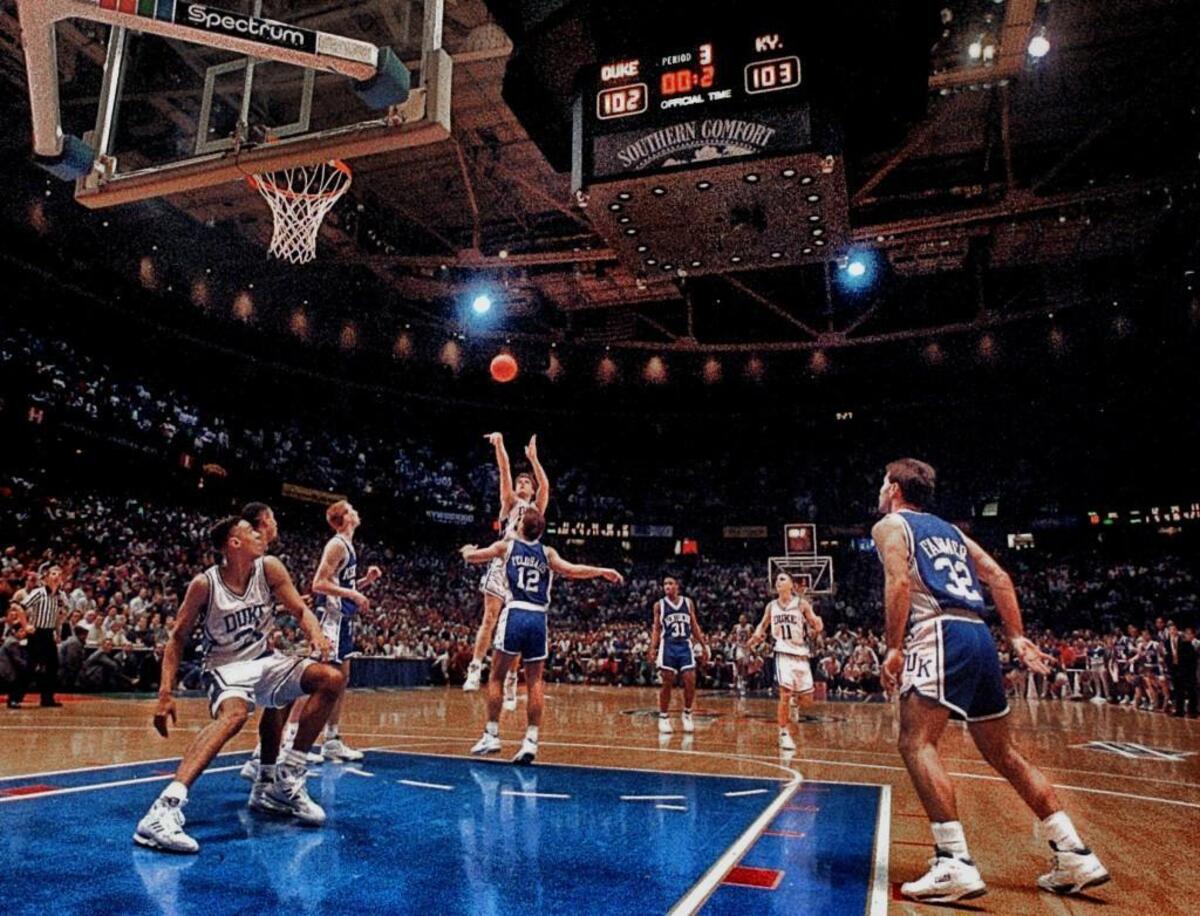 Duke’s Christian Laettner shoots over Kentucky’s Deron Feldhaus with 2.1 seconds left in overtime. “The Shot” sent the Blue Devils to the Final Four as Duke beat the Wildcats 104-103.