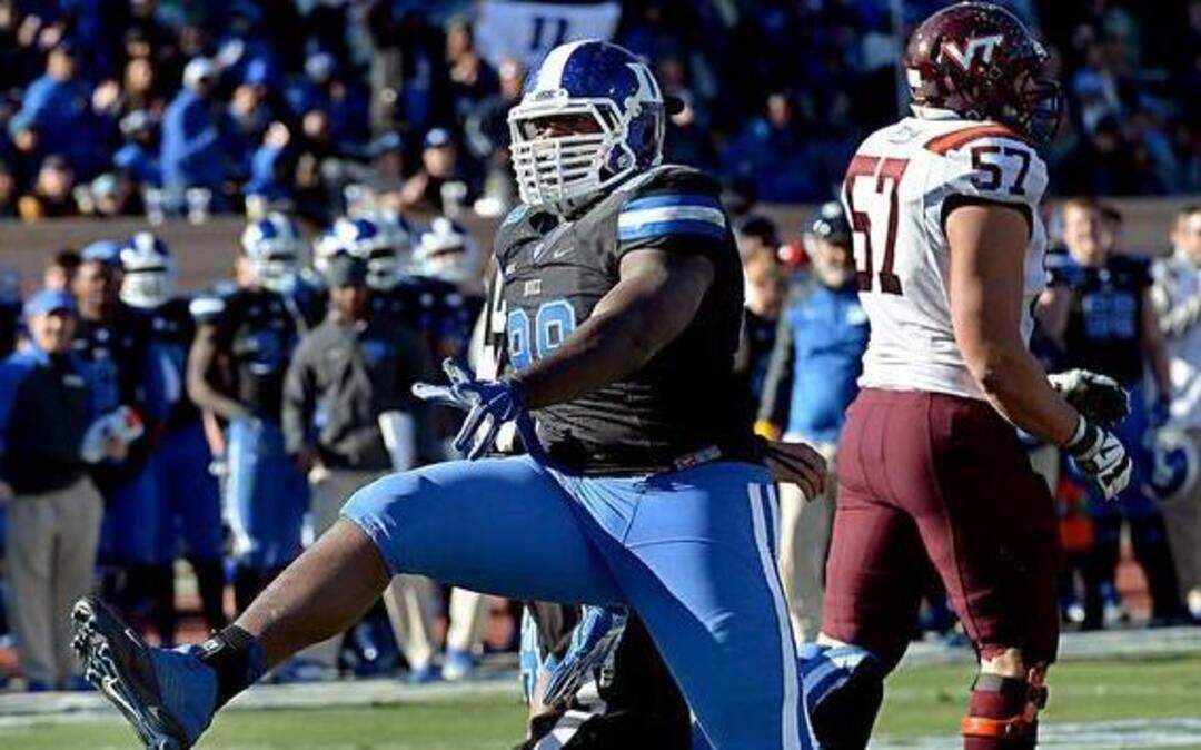 
Duke defensive tackle Carlos Wray (98) reacts after a fourth quarter sack of Virginia Tech quarterback Michael Brewer (12). Duke was beat by Virginia Tech 17-16 at Wallace Wade Stadium in Durham, NC Saturday, November 15, 2014.

