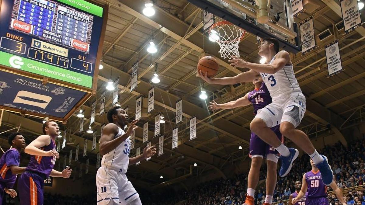 Duke guard Grayson Allen (3) attempts a first-half basket over Evansville forward Dainius Chatkevicius (14). Duke played Evansville at Cameron Indoor Stadium in Durham on Wednesday, Dec. 20, 2017.