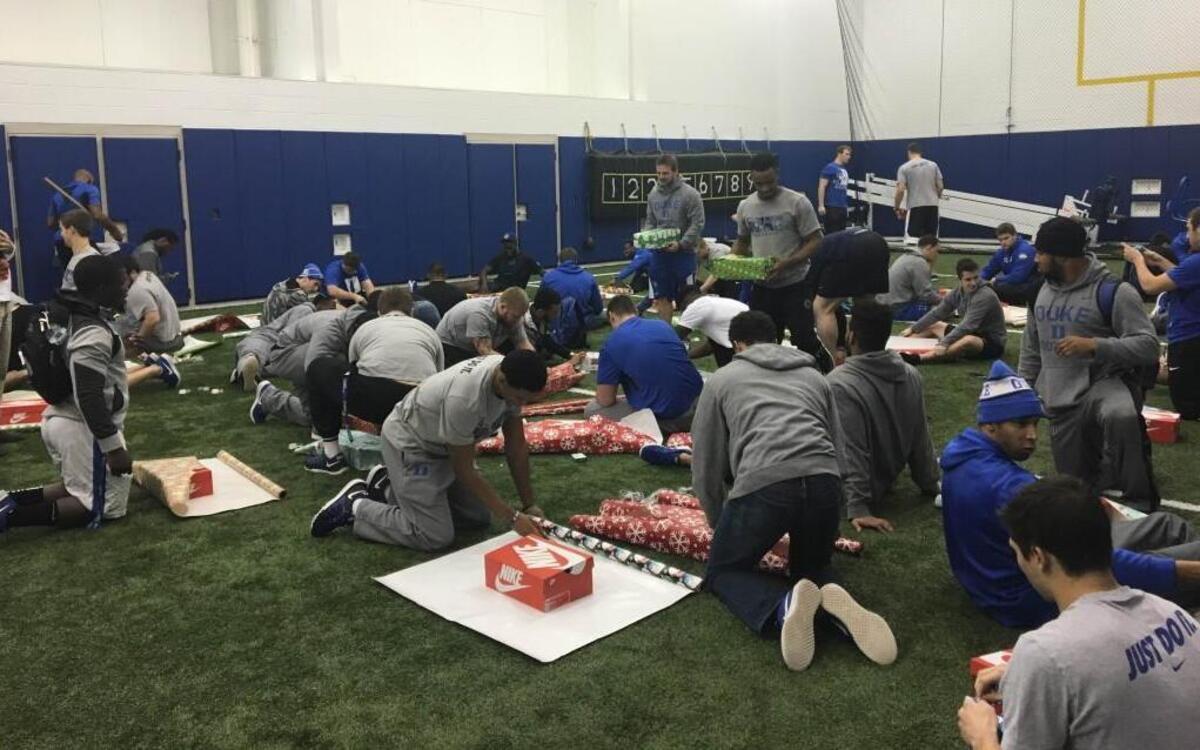 The Blue Devils wrap presents Dec. 16 for the shoebox gift wrapping project, which benefits the Durham parks and recreation department.