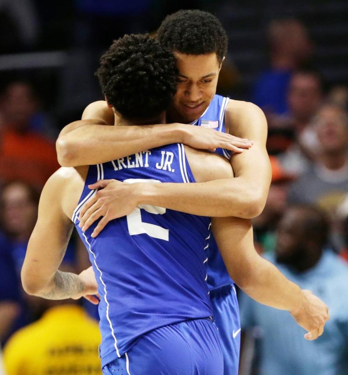 Duke's Justin Robinson hugs Gary Trent Jr (2) during the second half.