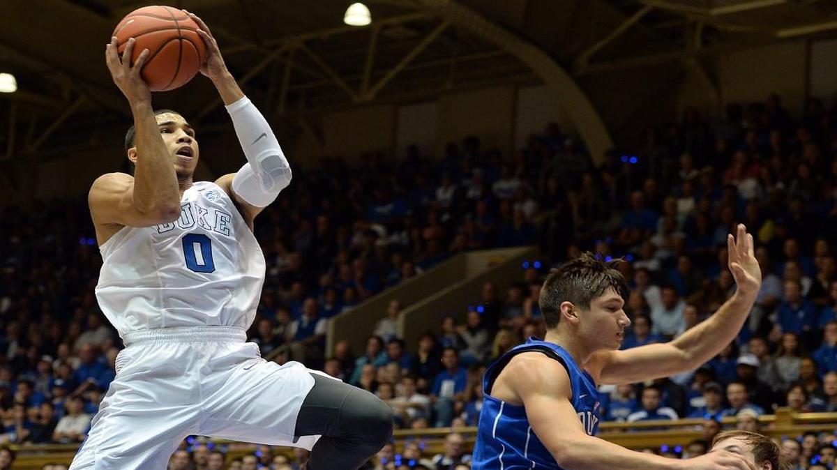 Duke forward Jayson Tatum, left, sails over guard Grayson Allen, right, to score during the annual Blue-White scrimmage on Oct. 22. Tatum sprained his left foot Tuesday and is expected to be out for two weeks.