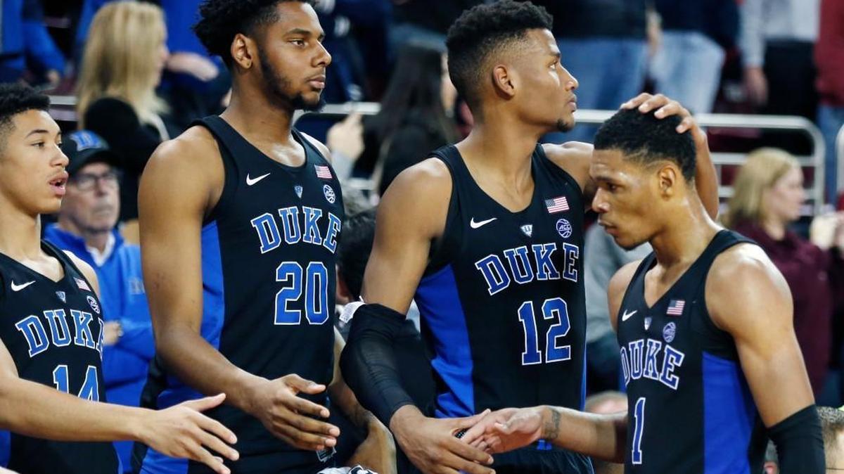 Duke's Jordan Goldwire (14), Marques Bolden (20) and Javin DeLaurier (12) meet Trevon Duval (1) as he comes off the court during the second half of an NCAA college basketball game against Boston College in Boston, Saturday, Dec. 9, 2017. Boston College won 89-84.