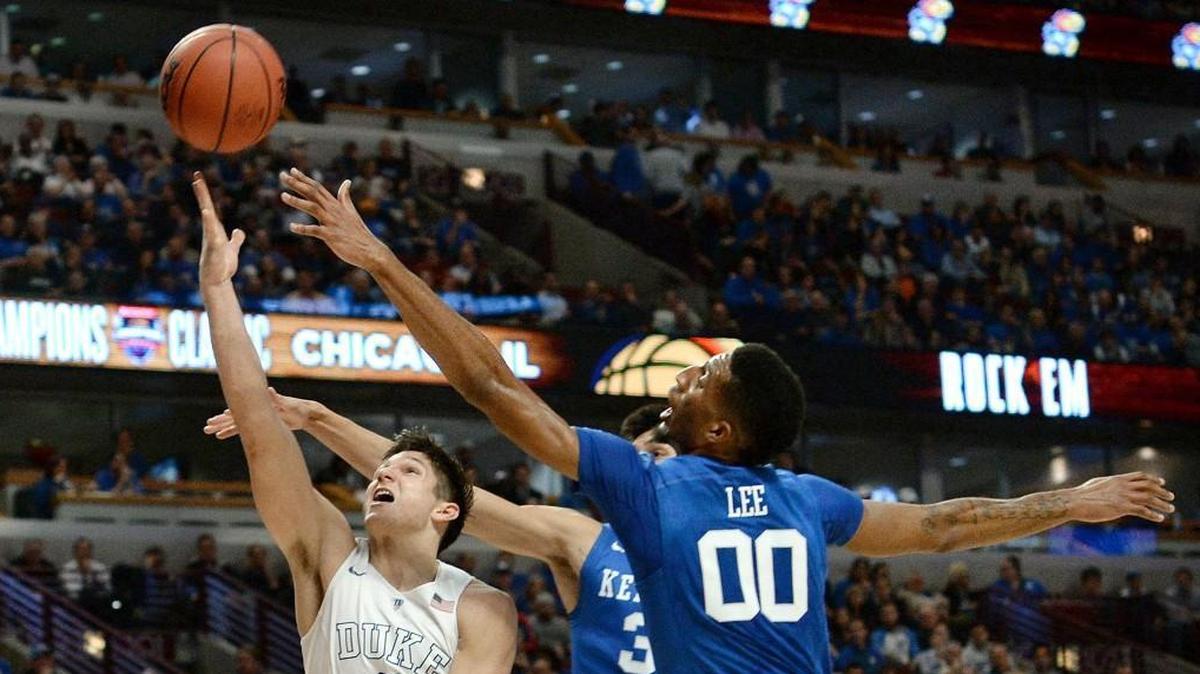 Duke guard Grayson Allen, left, tries to split Kentucky defenders forward Marcus Lee, right, and forward Derek Willis in 2015.
