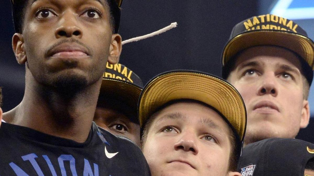 Duke players watch "One Shining Moment" after Duke's 68-63 victory over Wisconsin in the 2015 Division I Men's Basketball Championship game at Lucas Oil Stadium in Indianapolis, Ind., Monday, April 6, 2015. From left: Amile Jefferson, Grayson Allen,and Marshall Plumlee.