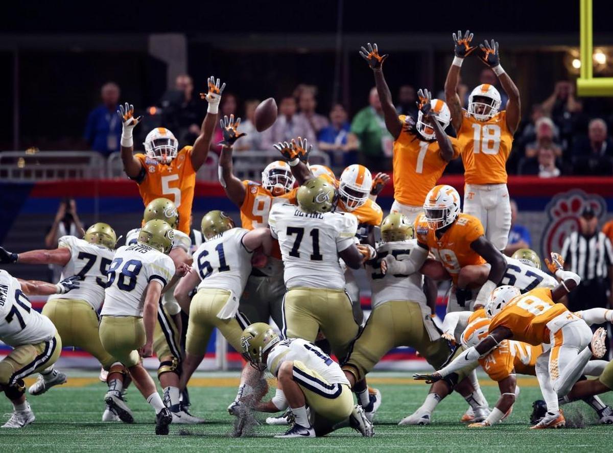 Georgia Tech place kicker Shawn Davis (88) has his field goal attempt blocked by Tennessee defensive lineman Paul Bai, center, in the final seconds of the second half on Monday.
