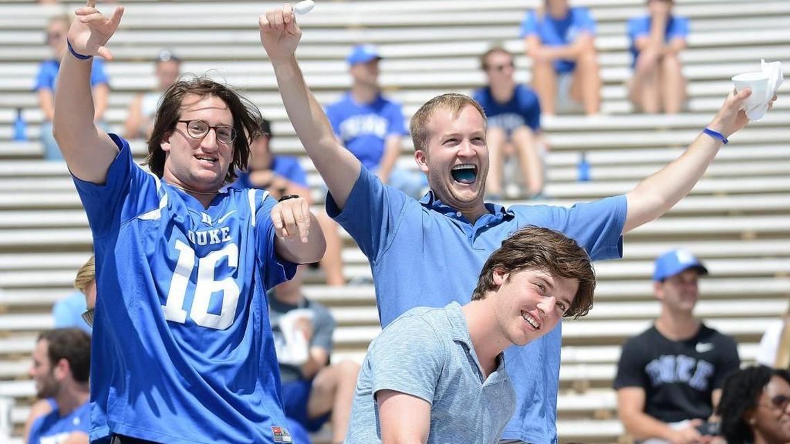 Duke students at Wallace Wade Stadium cheer on the Blue Devils against Northwestern with sparse crowds around them. The school’s announced attendance for Saturday’s 41-17 win over the Wildcats was 20,241.