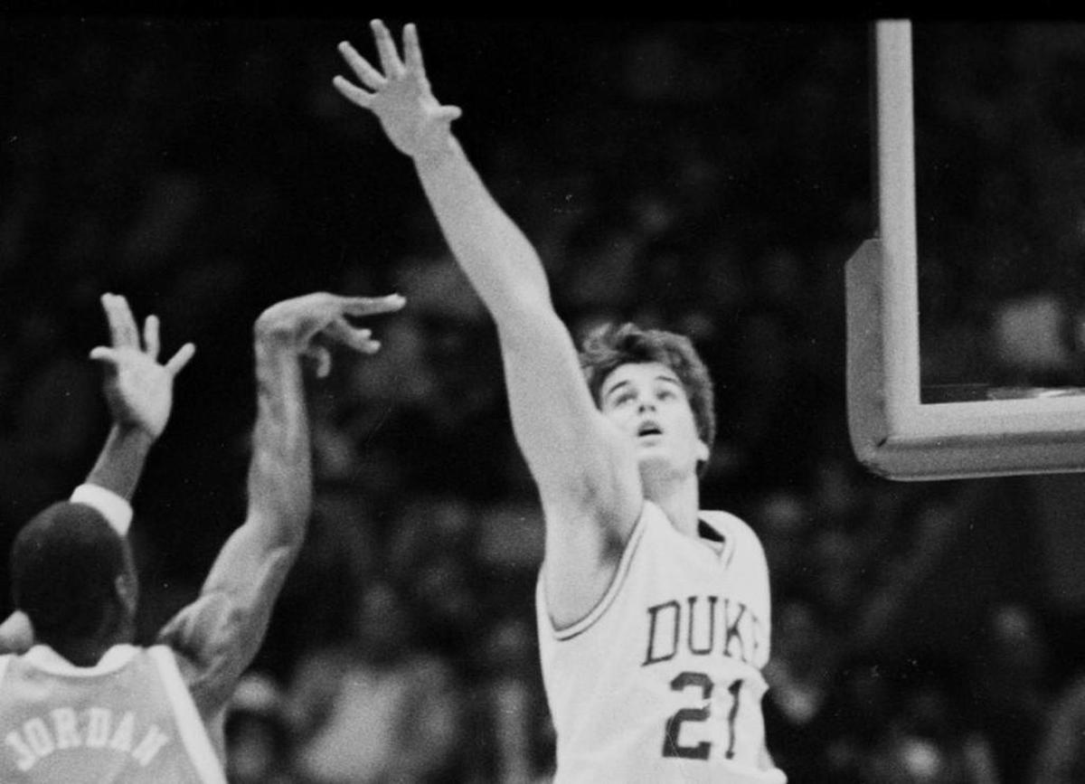 North Carolina’s Michael Jordan, left, shoots as Duke’s Jay Bilas defends during the March 10, 1984, ACC tournament semifinal game in Greensboro. Bilas was an undersized center for Duke in the 1980s.