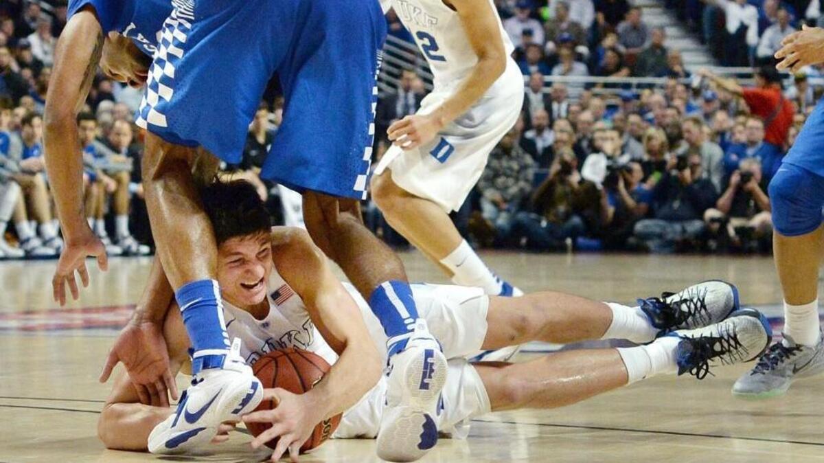 Duke guard Grayson Allen (3) goes to the floor to grab a loose ball with Kentucky forward Marcus Lee (0) on Nov.