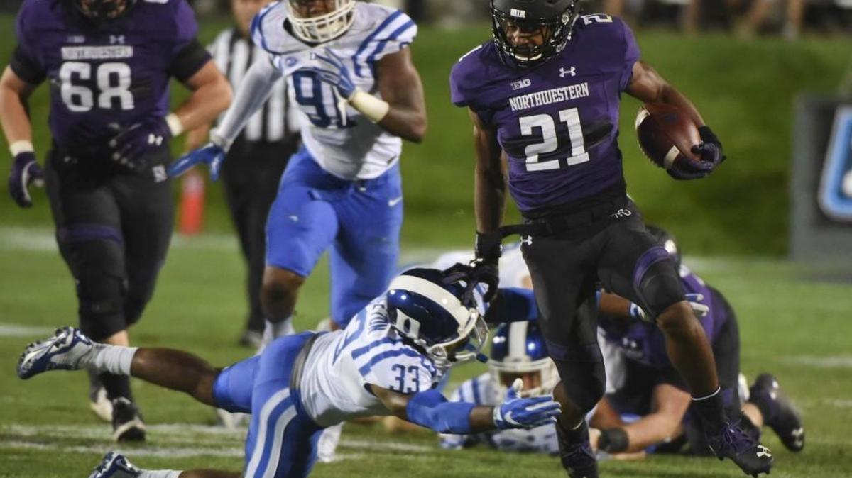 Northwestern running back Justin Jackson (21) runs against Duke safety Deondre Singleton (33) during the first quarter in Evanston, Ill.