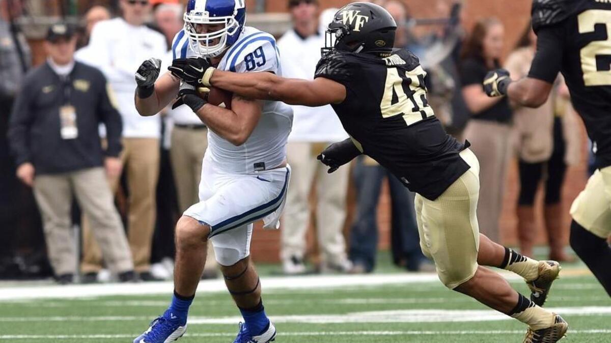 Duke’s Braxton Deaver runs with the ball against Wake’s Brandon Chubb on Saturday. The Blue Devils beat the Demon Deacons 27-21, winning a game they should have won.
