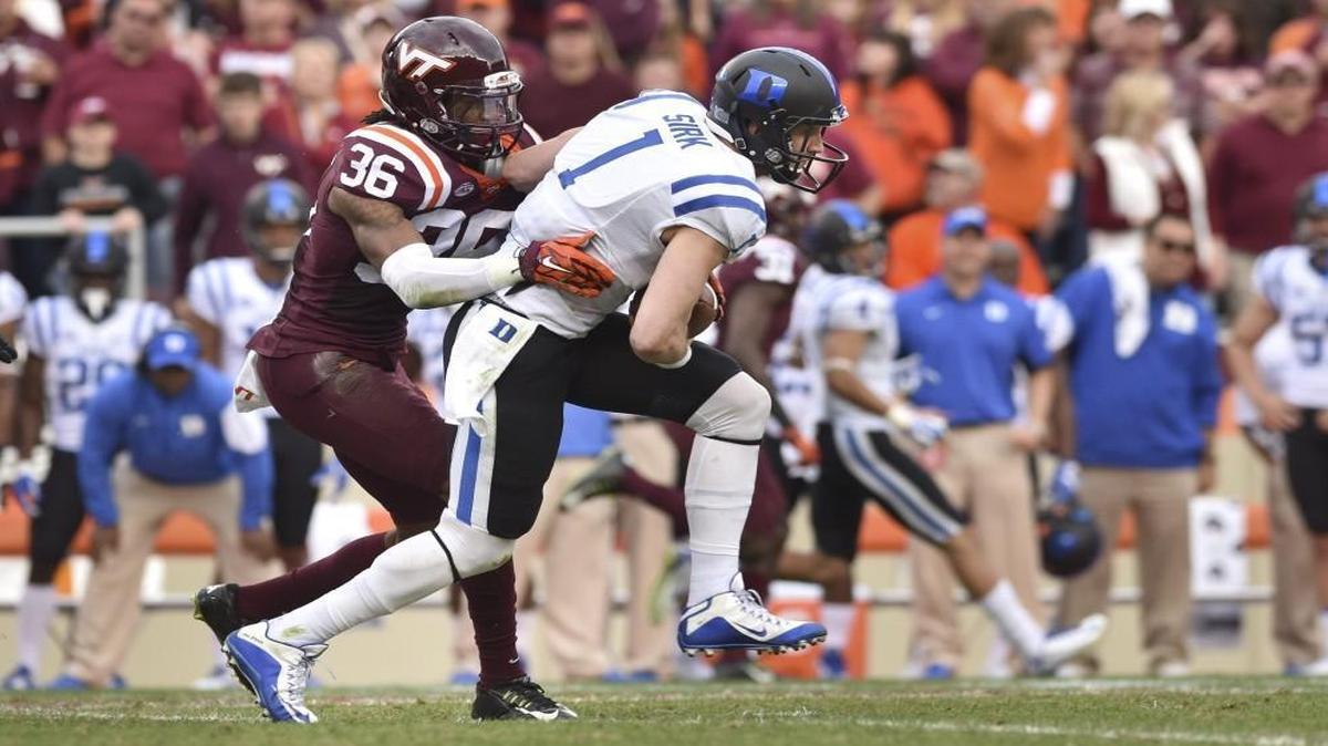 Duke quarterback Thomas Sirk carries the ball as Virginia Tech’s Adonis Alexander attempts a tackle in the second half at Lane Stadium in Blacksburg.