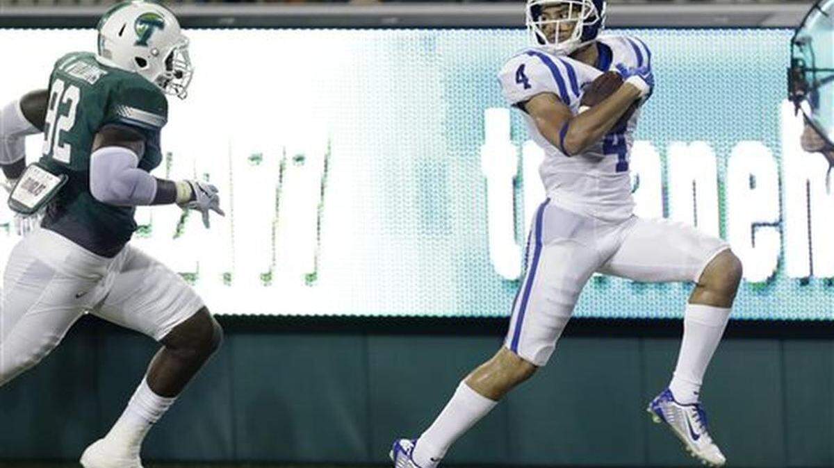 
Duke wide receiver Johnell Barnes (4) carries the ball past Tulane defensive end Daren Williams (92) for a touchdown in the second half of an NCAA college football game in New Orleans on Thursday.
