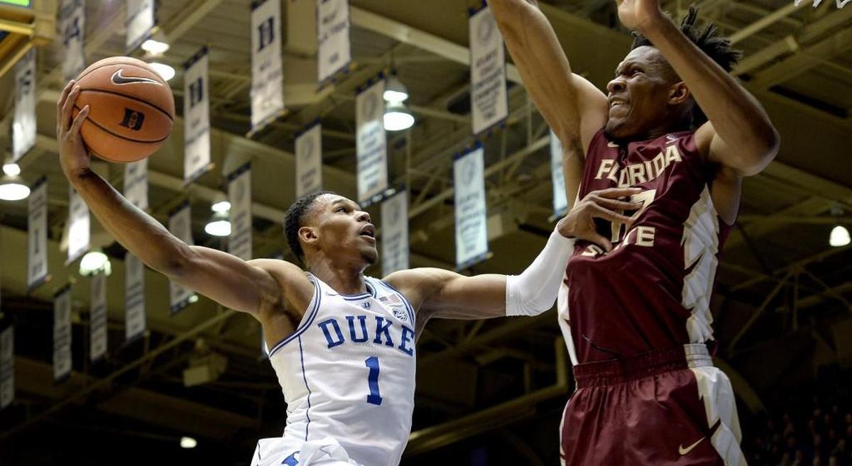 Duke guard Trevon Duval (1) goes in against Florida State center Ike Obiagu (12) in the first half of play. Duke played Florida State at Cameron Indoor Stadium in Durham, N.C. Saturday, Dec. 30, 2017.