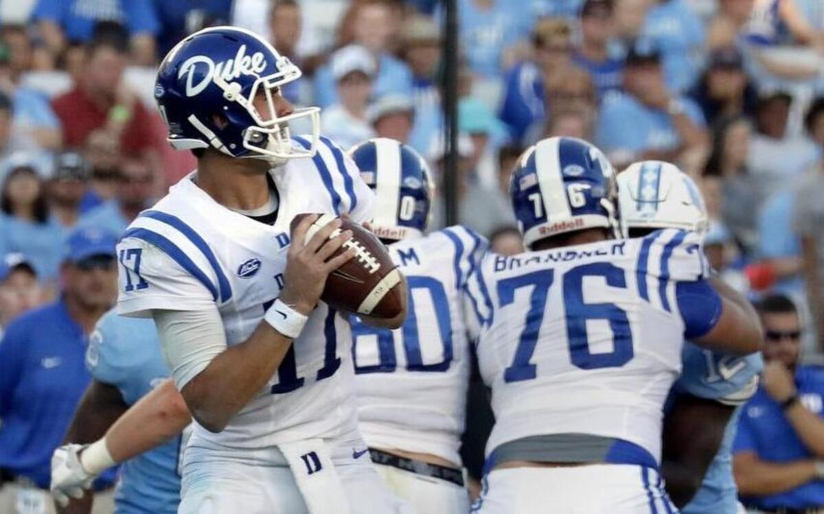 Daniel Jones, left, goes to make a pass behind the block of Gabe Brandner, 76, during Duke’s win at UNC on Sept. 23. Brandner suffered a hamstring injury against Virginia on Oct. 7 and may not play against Florida State on Oct. 14.