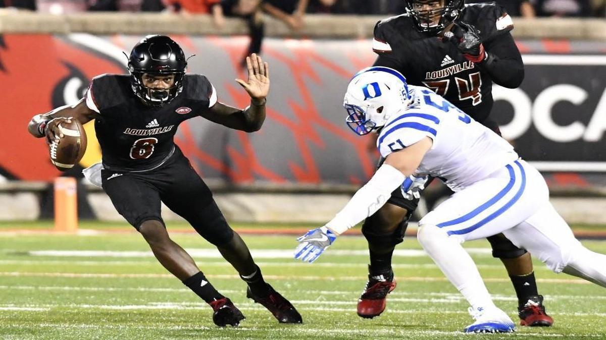 Louisville quarterback Lamar Jackson (8), sidesteps Duke defensive end Dominic McDonald (51) during the second half.